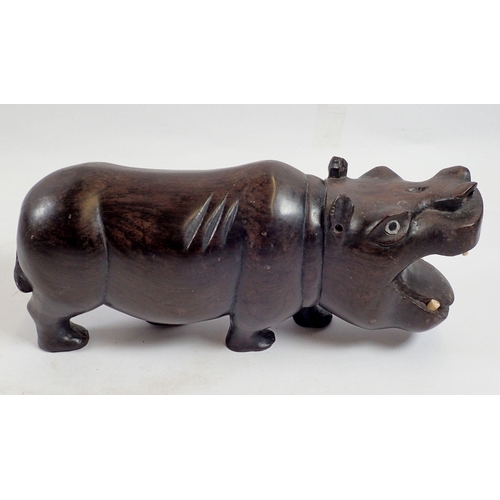 964 - An African carved rosewood hippo with bone teeth, 25cm long