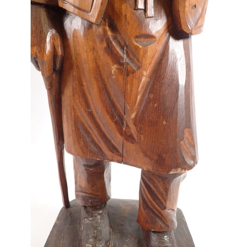 968 - A Black Forrest large carved figure of an old man with pipe, 52cm