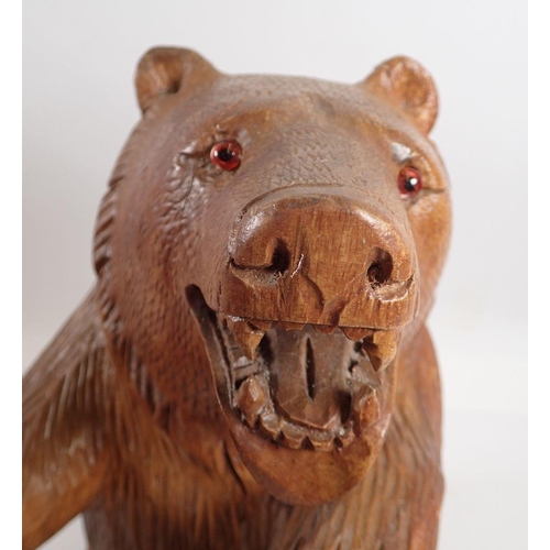 969 - A large Black Forrest carved wooden bear, 35cm tall