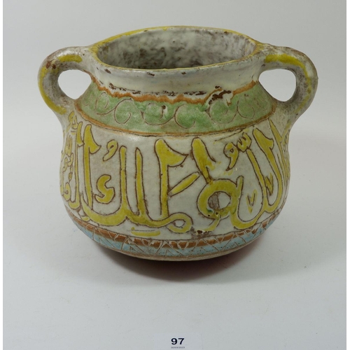 97 - A Middle Eastern pottery two handled pot with script, 21cm