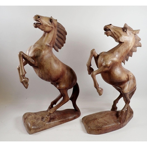 975 - A pair of large carved wooden horses, both a/f - largest 49cm