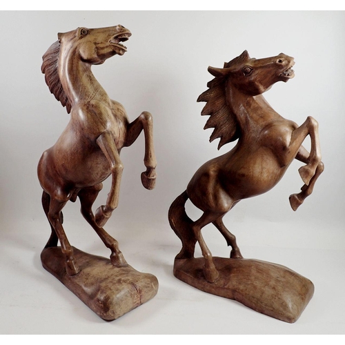 975 - A pair of large carved wooden horses, both a/f - largest 49cm