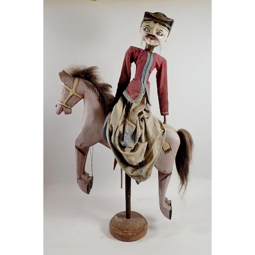 976 - An Indian painted wood puppet on a horse, 60cm tall