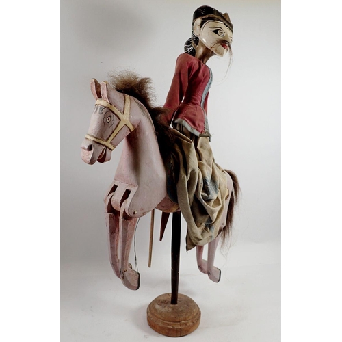 976 - An Indian painted wood puppet on a horse, 60cm tall