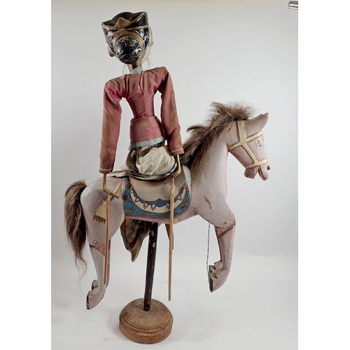 976 - An Indian painted wood puppet on a horse, 60cm tall