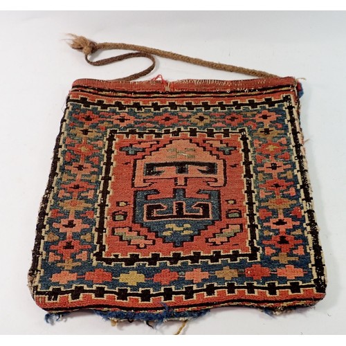 1335 - A Soumak antique saddle bag, 33cm square and a carpet hanging