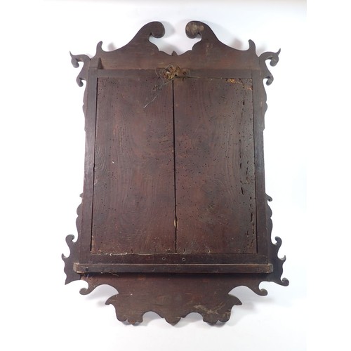 1353 - An early 18th century mahogany framed mirror with fret cut top and apron, 68 x 51cm