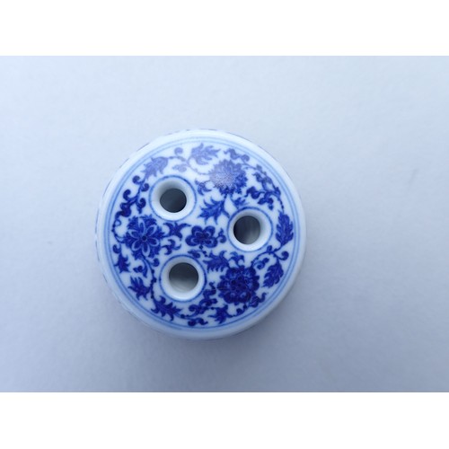 167 - A Chinese Imperial style blue and white incense burner with scrolling floral motifs 