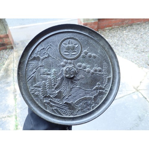 1077 - A Chinese bronze circular mirror cast landscape scene and text, 20cm