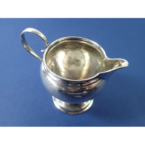 387 - An Arts & Crafts silver hammered cream jug, Birmingham 1909 by Liberty & Co. 46g, 7.5cm