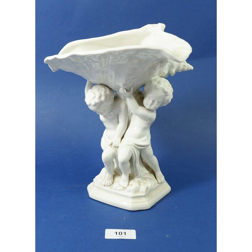 101 - A Sitzendorf figure group of cherubs holding a clam with cross blue stamp to base, 25cm high