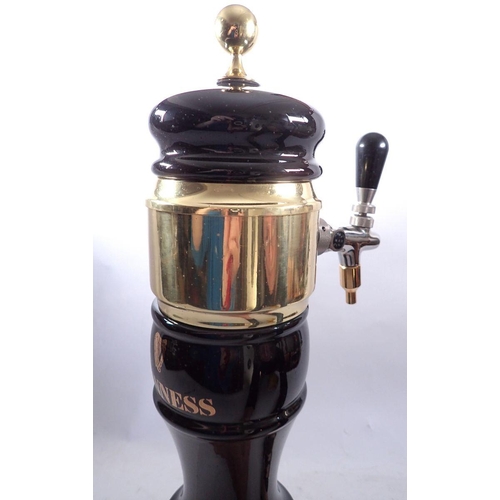 1096 - A Guinness black and gold bar pump with tap, 50cm tall