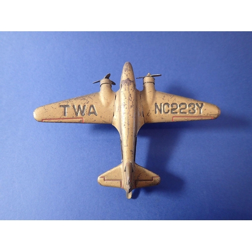 1118 - A 1930s tin plate clockwork plane, TWA NC2237 with clockwork motor, 12cm long