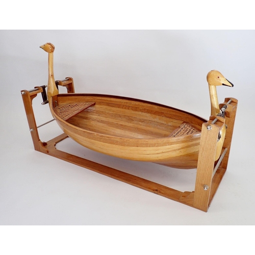 1127 - An unusual wooden childs rocking boat with duck head decoration to ends, 128cm long