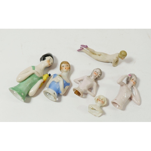 113 - Five porcelain pin dolls and a miniature bisque nude, 8cm