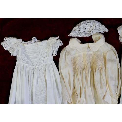 1138 - An Edwardian silk childs dress, three white cotton christening gowns and two bonnets