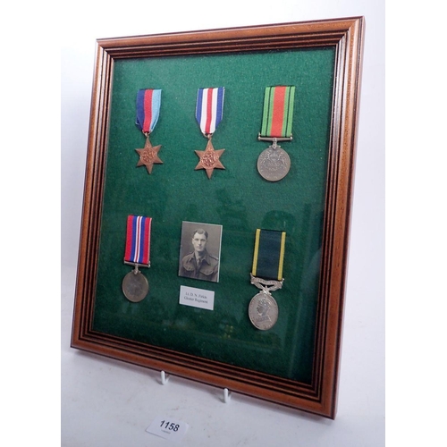 1158 - A framed collection of five WWII medals with photo of Lt D N Firkin, Gloster Regiment, frame 39 x 33... 