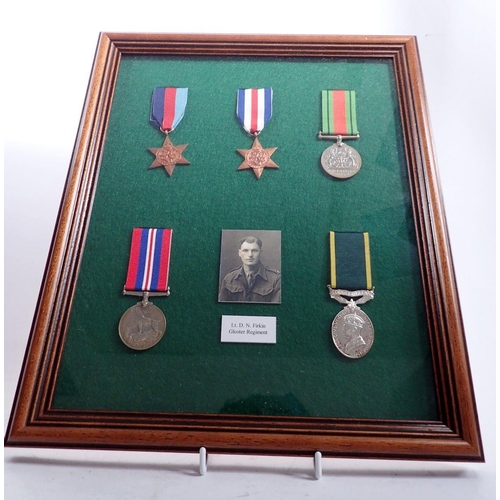 1158 - A framed collection of five WWII medals with photo of Lt D N Firkin, Gloster Regiment, frame 39 x 33... 