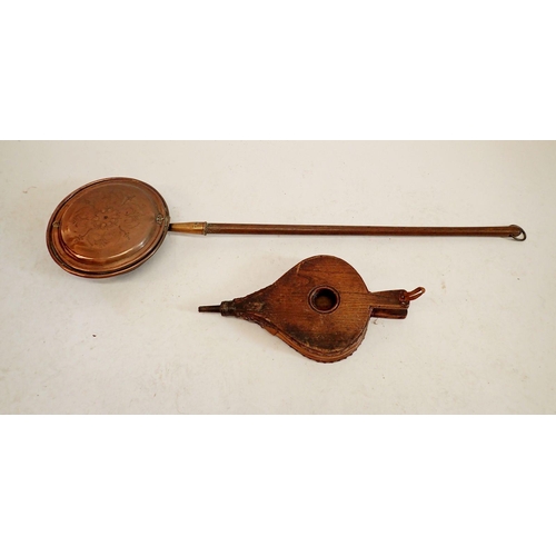 1181 - A Victorian copper warming pan with engraved decoration, 123cm long and a pair of elm bellows, 50cm ... 