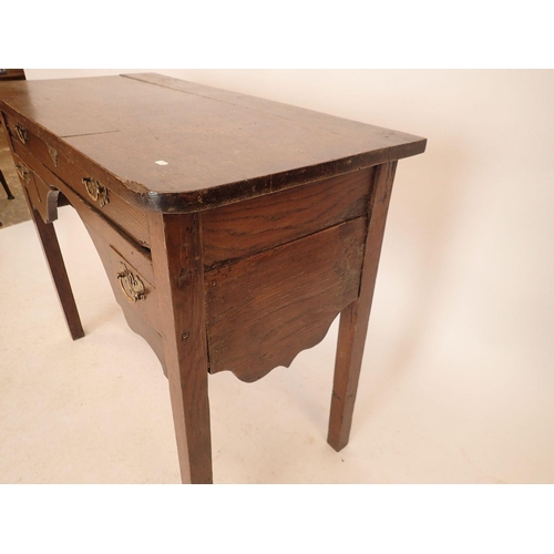 1192 - A Georgian oak low boy with frieze drawer and two small drawers, shaped side apron and square suppor... 