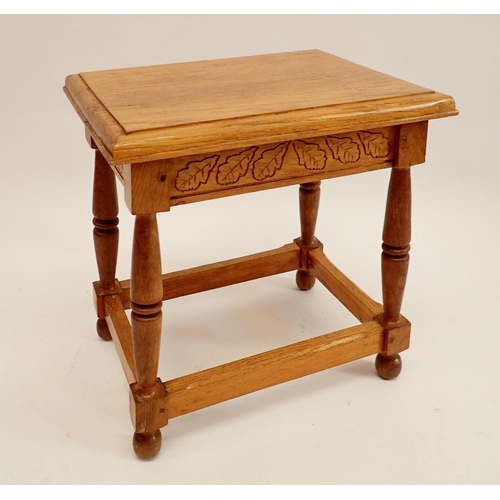 1194 - A golden oak joint stool with carved oak leaf decoration, 48cm high