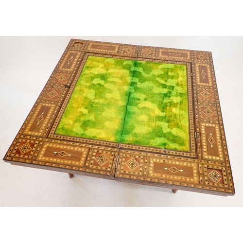 1209 - A Damascus marquetry fold top games table with card baize, backgammon and chess boards