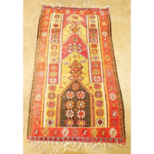 1226 - A red and green kelim rug with floral and motif decoration, 190cm long x 110cm wide