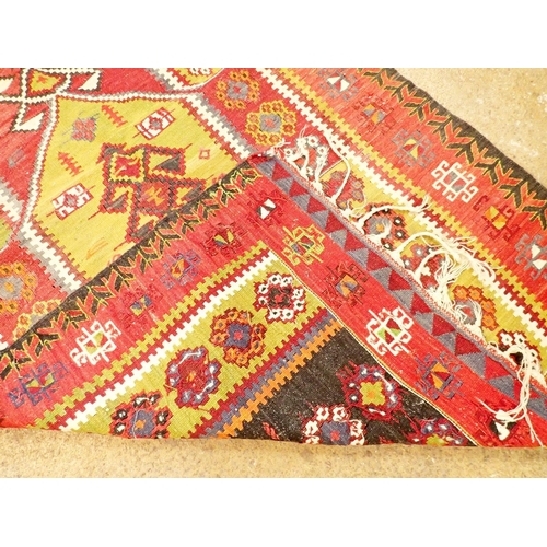 1226 - A red and green kelim rug with floral and motif decoration, 190cm long x 110cm wide