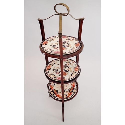 1233 - An Edwardian inlaid mahogany three tier cake stand with brass handle and three inset Masons Ironston... 