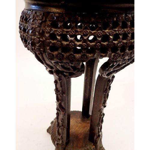 1234 - A Chinese small hardwood jardiniere stand with inset marble top and all over carved prunus decoratio... 