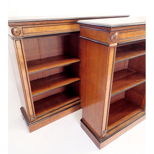 1235 - A pair of fine of Victorian oak and ebonized dwarf bookcases with leather inset tops, adjustable she... 