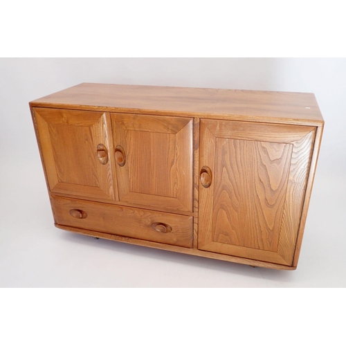 1239 - An Ercol retro Golden Dawn blonde elm sideboard consisting of two cupboards and drawer standing on f... 