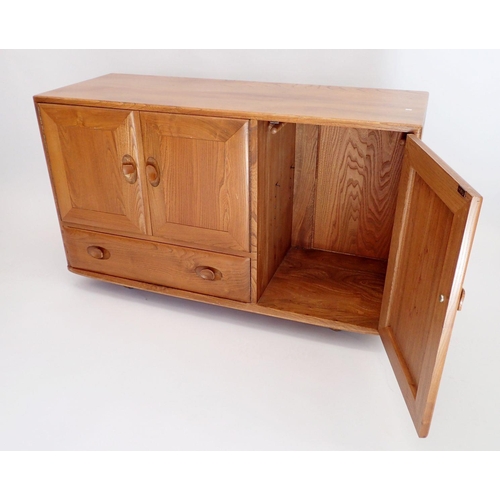 1239 - An Ercol retro Golden Dawn blonde elm sideboard consisting of two cupboards and drawer standing on f... 