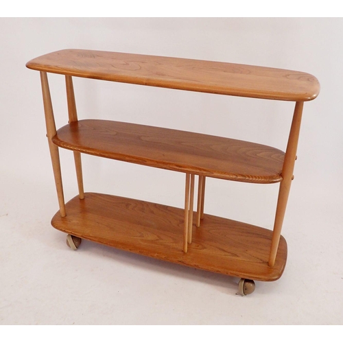 1240 - An Ercol retro blonde Giraffe No 361 trolley bookcase room divider on castors, 91cm long x 71cm high