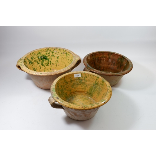 1254 - Three various glazed terracotta bread crocks, 32cm diameter