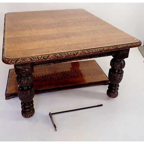 1287 - A Victorian large oak dining table with carved border and heavily carved bulbous supports, with two ... 