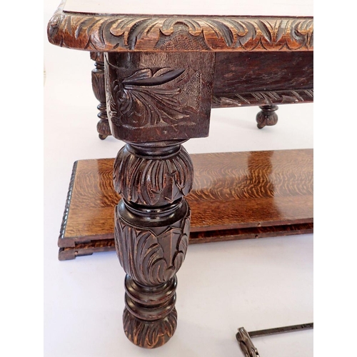 1287 - A Victorian large oak dining table with carved border and heavily carved bulbous supports, with two ... 