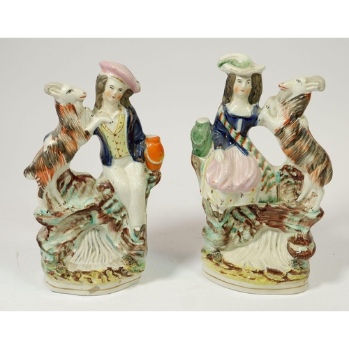 61 - A pair of Victorian Staffordshire figures of man and a lady with goats, 20cm tall