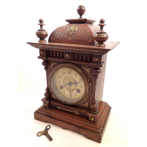 737 - A Victorian carved oak mantel clock, 35cm tall