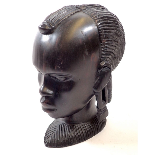 762 - An African amboyria carved wood head, 23cm tall