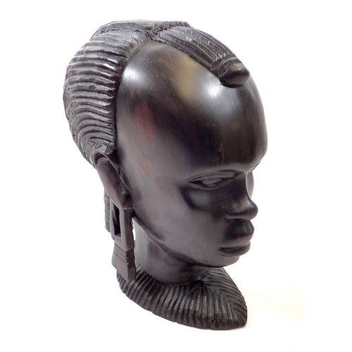 762 - An African amboyria carved wood head, 23cm tall