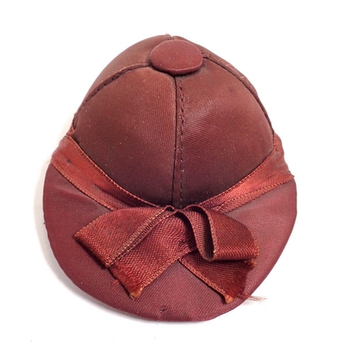 766 - A silk jockey hat pin cushion, 7cm