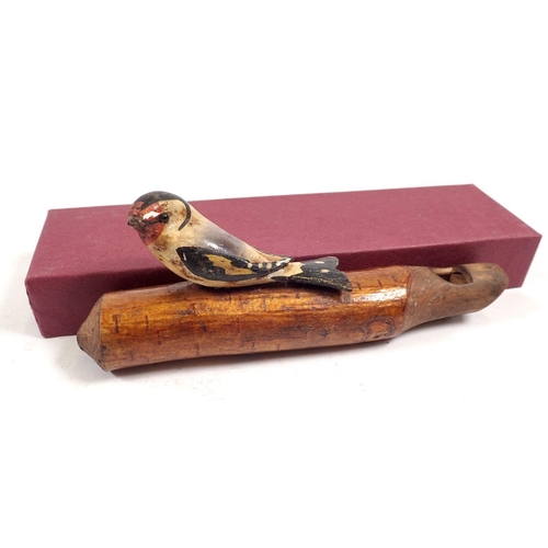 773 - An early 20th century natural wood whistle with carved and applied goldfinch, 16cm