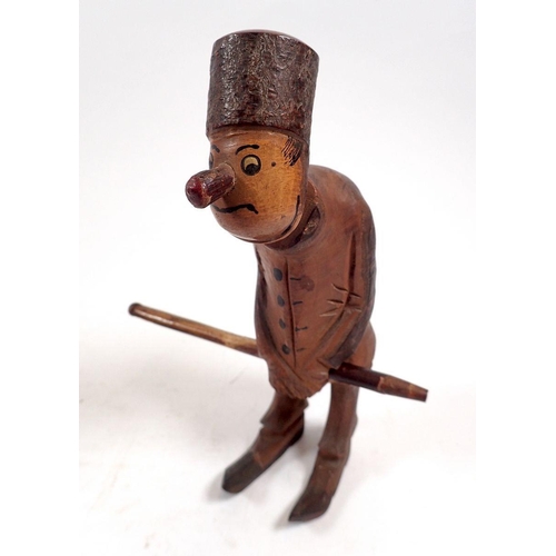 799 - A collection of eight pipes including a carved man concealing a pipe standing 17cm tall