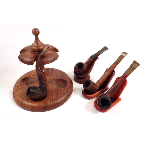 805 - A teak pipe stand with three individual stands and four pipes