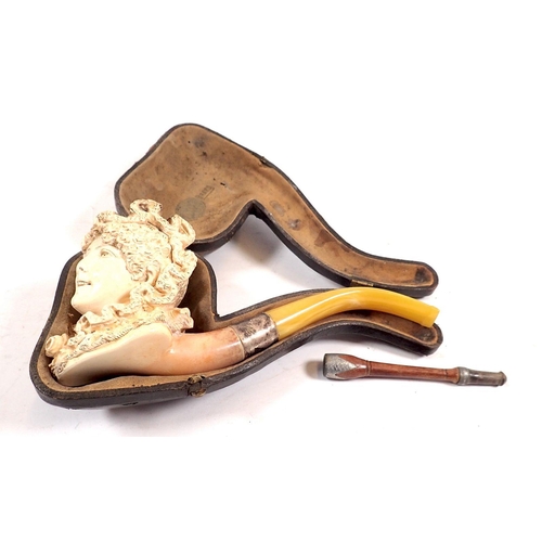 806 - A 19th century Meerschaum pipe in form of a ladies head, cased and a cigarette holder