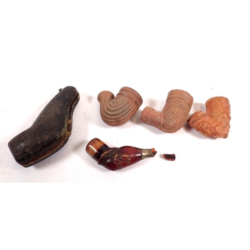 807 - A Meercham pipe in form of a leg with garter, a/f and three antique terracotta pipe bowls