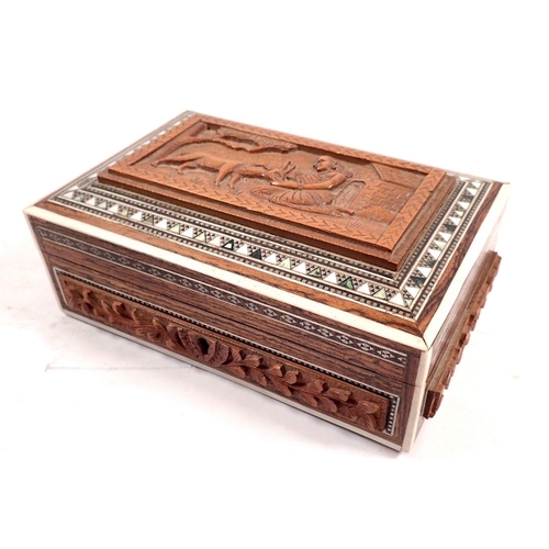 814 - An Indian box carved woman feeding deer within inlaid border, 15cm wide