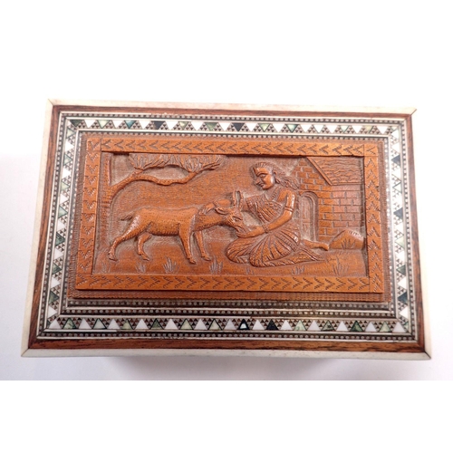 814 - An Indian box carved woman feeding deer within inlaid border, 15cm wide