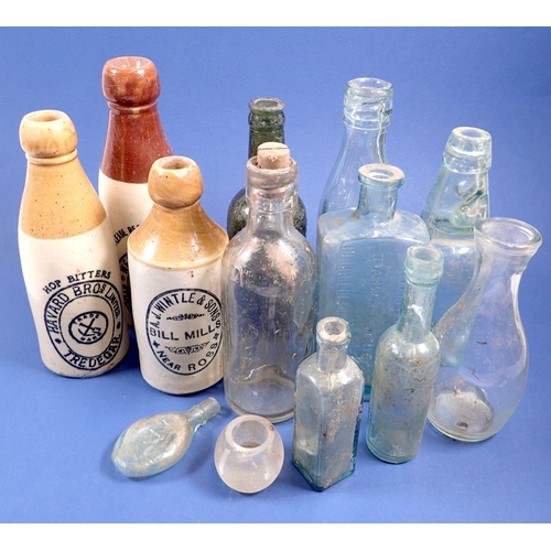 837 - A collection of glass and stoneware bottles with printed labels etc.